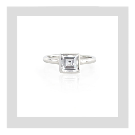 Platinum engagement ring featuring a carré cut diamond.