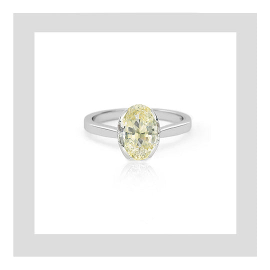 Handcrafted platinum engagement ring featuring a 1.01ct natural oval yellow diamond.