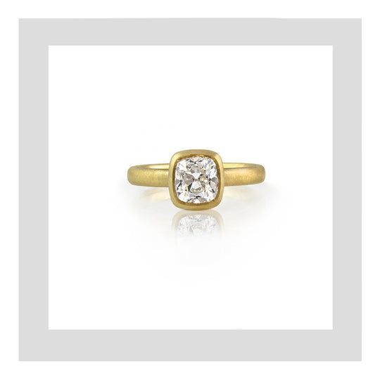 18ct satin finish yellow gold engagement ring with a 1.25ct cushion cut diamond.